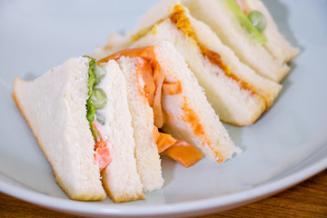 delicious sandwich with ham vegeable bread on  white dish , home made sandwich, health food