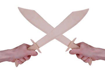 Crossed wooden sabres isolated over white background.