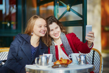 Two young girls in Parisian outdoor cafe