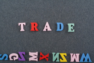 TRADE word on black board background composed from colorful abc alphabet block wooden letters, copy space for ad text. Learning english concept.