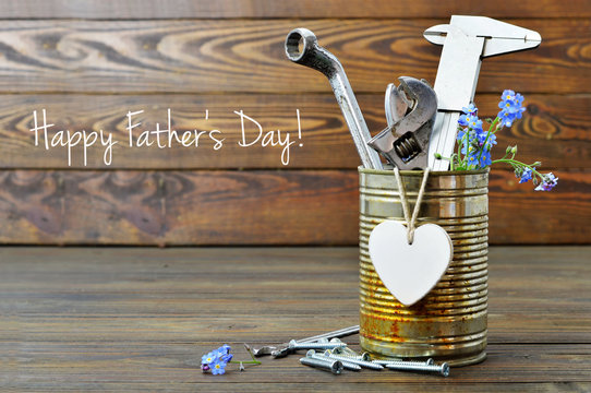 Happy Fathers Day Card With Tools, Heart And Flowers On Wooden Background