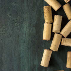Wine corks on dark wooden texture with copyspace
