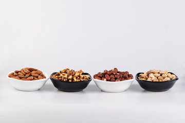 Assorted nuts in ceramic bowls