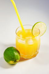 Fototapeta premium Cocktail with orange juice in a glass. Mint leaves. Lime. Orange fresh with ice. Freshness. Cold drink. Thirst quenching. Alcohol Cocktail 