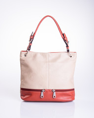 bag or brown leather woman handbag on background.