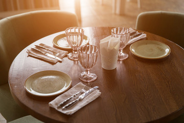 Empty glasses and dishes set in restaurant