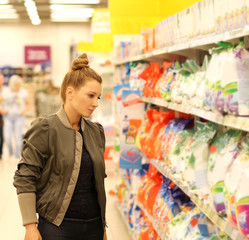 Woman choosing a dairy products at supermarket 