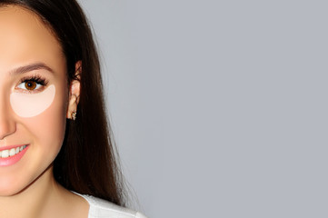 Close-up portrait of young pretty woman with underlined eye contour, area of black eye and first...