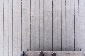 high angle view of grey wood boards on pier with feet