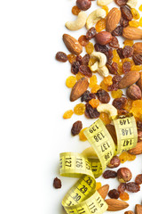 Various nuts and raisins with measuring tape.