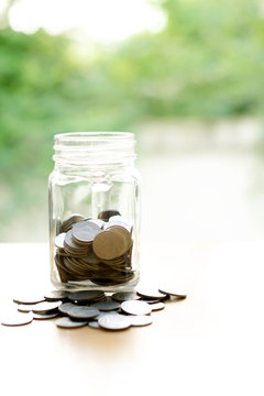 Coins Into Glass Jar
