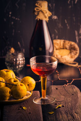 Bottle liquor wooden table ingredients tincture fruit quince