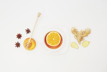 Herbal tea with lemon and ginger over white background. Flat lay, top view, copy space