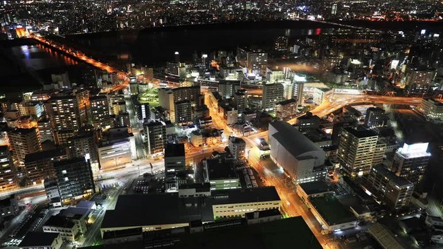 Japan aerial view of Osaka City Central Business downtown at night. Beautiful night scene of Osaka Skyline from Kita ward of Japan. Osaka nightscape close up time lapse.