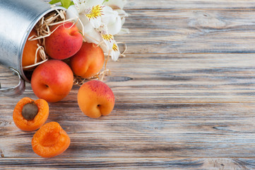 Closeup of fresh apricots in tin mug