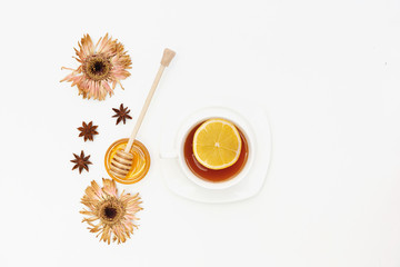 Lemon tea with honey and nice over white background. Flat lay, top view, copy space