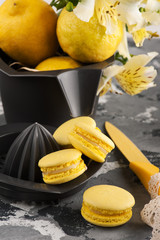Yellow macaroons with lemons in background
