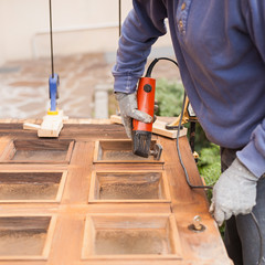 Carpenter at work with angular Sander.