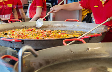 Seafood paella in a paella pan at a street food market
