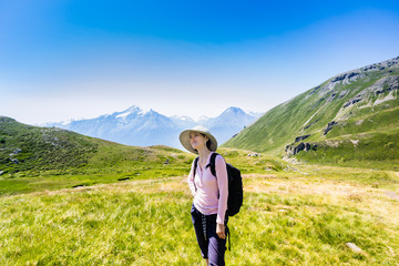Naklejka na ściany i meble Woman hiking in mountains at summer