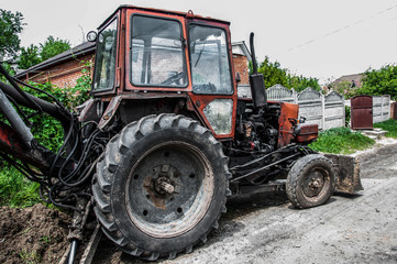Obraz premium Excavator digs a hole on the road. Background blur