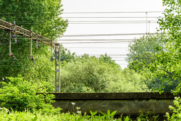 Metal high voltage electric supply cables over railway