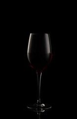 Red wine glass isolated on black background