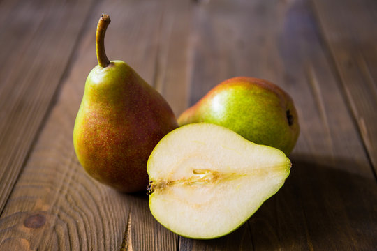 Pears on a wooden background and burlap