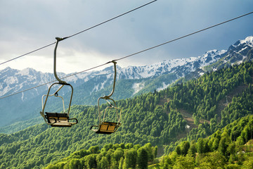 A canopy chairlift in the background of the mountains in the summer. Rosa Khutor, Adler
