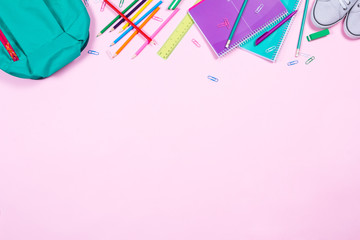 School stationery on pink background with copyspace