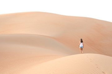 Beautiful woman hiking on giant sand dunes.
