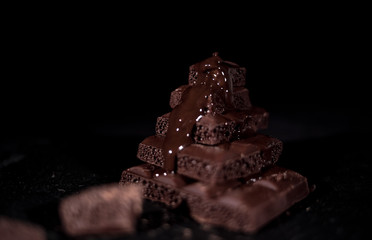 Dark chocolate on a black background