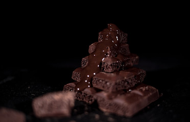 Dark chocolate on black background