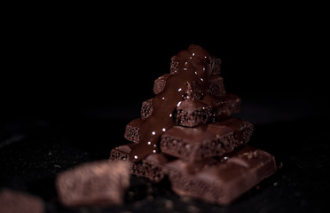 Dark chocolate on black background