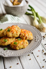 Baked small pies with ham and topped with cheese