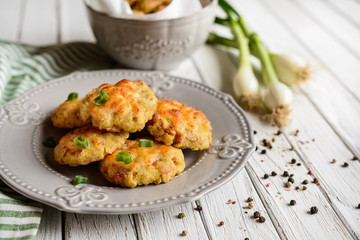 Baked small pies with ham and topped with cheese