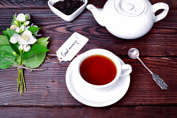 Cup of black tea and brewer
