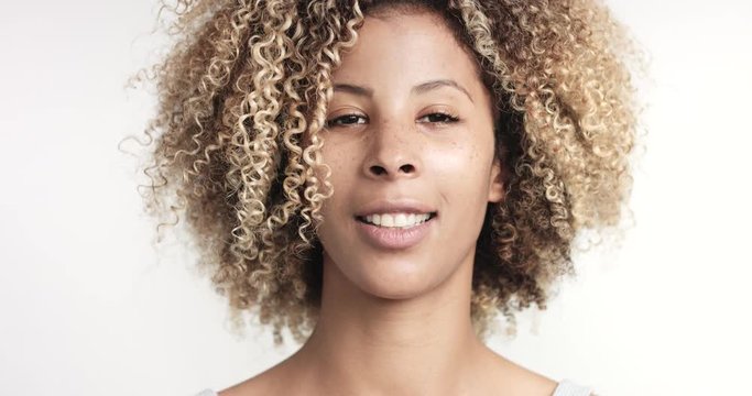 happy smiling black woman with afra makes shoots with photocamera