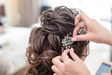 Fotobehang Hairdresser makes hairstyle bride © Elvira