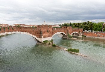 Fototapeta premium The Ponte Pietra (Stone Bridge), once known as the Pons Marmoreus, is a Roman arch bridge crossing the Adige River in Verona, Italy. The bridge was completed in 100 BC,