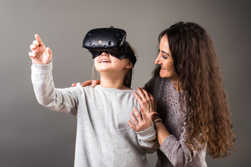 woman and girl wear with VR device and finger touch in air