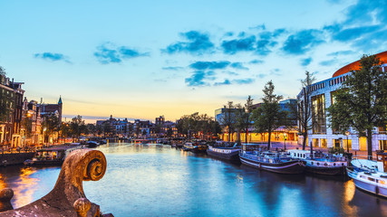 The most famous canals and embankments of Amsterdam city during sunset. General view of the...