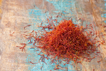 Fototapeta premium Dried organic red saffron Spice on wooden background