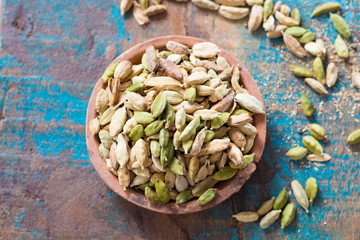 Raw Organic Cardamom Pods on wooden background ready to use