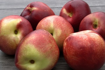 Nectarines on wooden table.