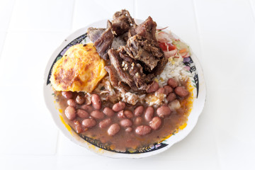 Meal in ecuadorian jungle area - beans, rice, plantains and peccary meat.