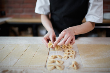 Person cooking pasta in cafe