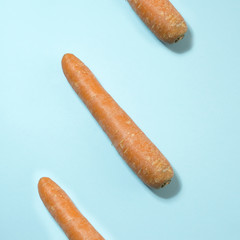 Composition of carrots on pastel blue background