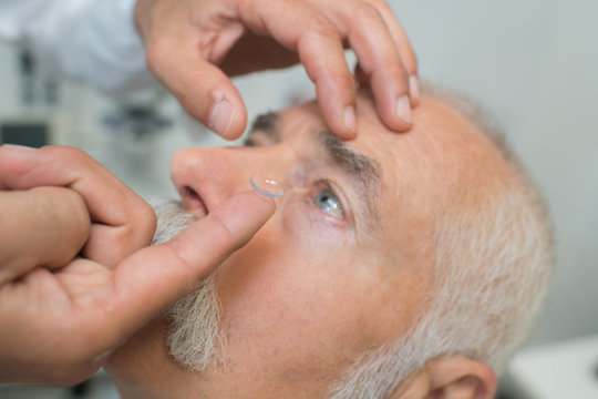 Man having contact lens put in his eye