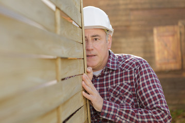 builder lining up cargo boxes outdoors a construction site